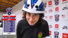 a skateboarder who just finished a winning run makes a silly face at the camera while still wearing her helmet