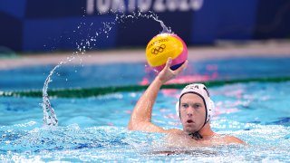 Ben Stevenson carries the ball for Team USA in a water polo game against Japan.