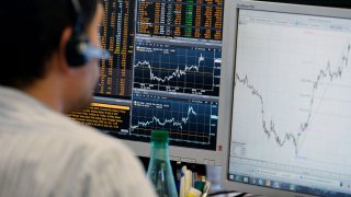 A trader checks his screens at investment bank Saxo Banque in Paris on June 23, 2016. European stocks rallied and the pound hit its highest level on June 23 as markets expected the Remain camp to come out on top in Britain’s referendum on EU membership.