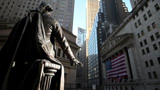 A statue of George Washington is pictured in front of the New York Stock Exchange on Wall Street in New York City.