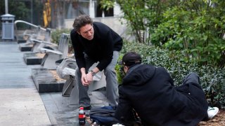 Miracle Messages founder and CEO Kevin F. Adler with a homeless man in San Francisco’s Union Square on Jan. 29, 2019.