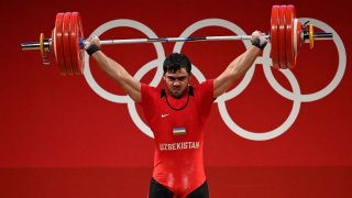 Akbar Djuraev of Uzbekistan competes in the men's 109 kg weightlifting competition at the 2020 Tokyo Olympic Games.
