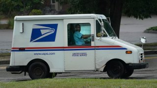 U.S. Postal Service carrier John Graham drives a 28-year-old delivery truck