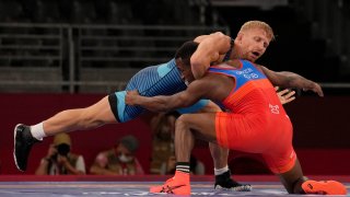 Kyle Dake, top, competes against Cuba's Jeandry Garzon Caballero during their men's freestyle 74kg repechage wrestling match at the 2020 Summer Olympics, Friday, Aug. 6, 2021, in Chiba, Japan.