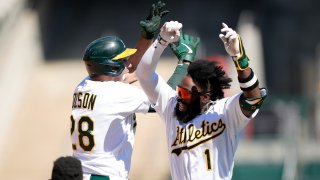 Matt Olson #28 and Josh Harrison #1 of the Oakland Athletics.