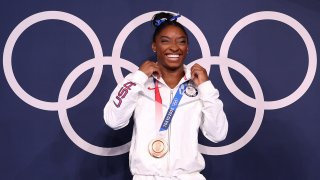 Biles smiles with her bronze medal.