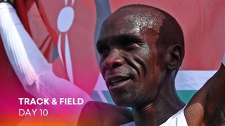 Eliud Kipchoge of Kenya winner of the gold medal crosses the finishing line and celebrates with a flag during the NN Mission Marathon