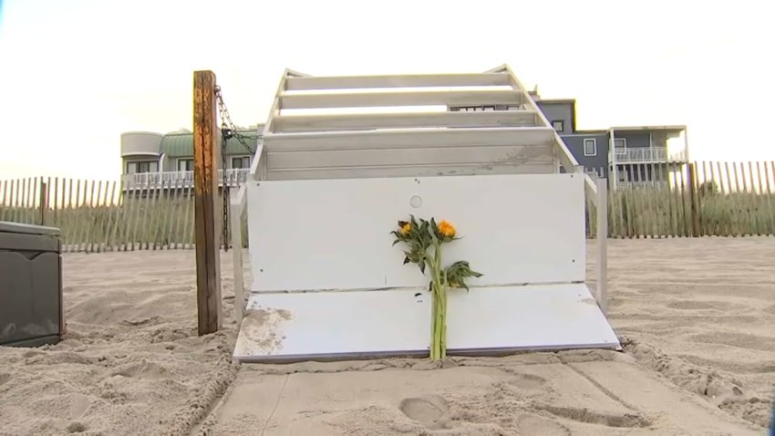 Knocked over lifeguard stands with flowers on it