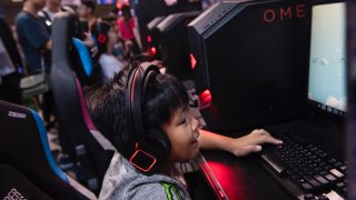 A boy plays computer games during the E-Sports and Music Festival Hong Kong.