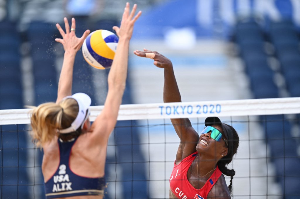 USA's Alix Klineman (L) blocks a shot by Cuba's Leila Consuelo Martinez Ortega in their women's beach volleyball round of 16 match between Cuba and the USA during the Tokyo 2020 Olympic Games at Shiokaze Park in Tokyo on Aug. 2, 2021.
