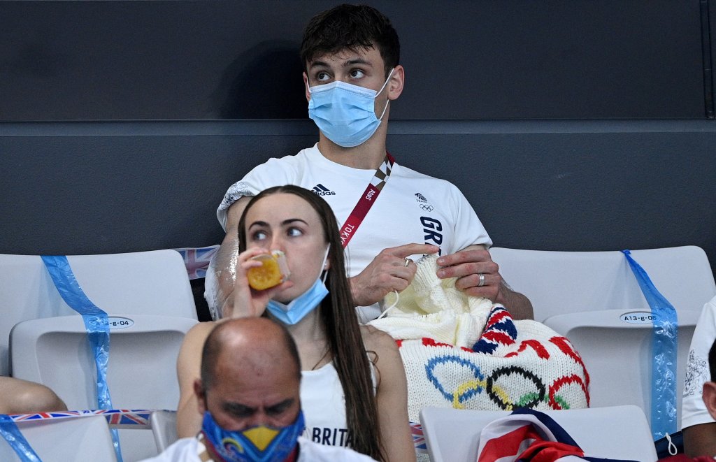 British diver Thomas Daley sits with his knitting as he watches divers