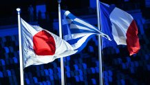 The flags of Japan, Greece and France waves in the Olympic Stadium during the Closing Ceremony of the Tokyo Olympics, Aug. 8, 2021, Tokyo.