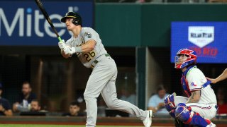 Matt Chapman #26 of the Oakland Athletics hits a home run in the seventh inning against the Texas Rangers at Globe Life Field on August 14, 2021 in Arlington, Texas.