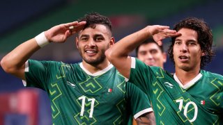 Alexis Vega and Diego Lainez of Mexico salute after Mexico increased its lead over Japan