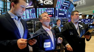 Traders work on the floor of the New York Stock Exchange (NYSE), September 21, 2021.
