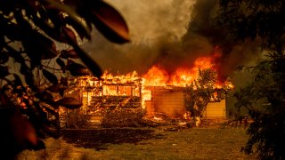 Flames consuming house as Fawn Fire burns