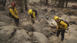 Firefighters work on hot spots during the Caldor Fire.