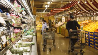 Customers wearing protective masks shop at a Stew Leonard's supermarket in Paramus, New Jersey