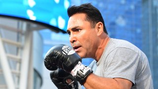 Former US Olympics gold medalist professional boxer Oscar De La Hoya spars with his partner during a media workout.