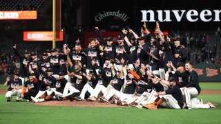 SAN FRANCISCO, CALIFORNIA – SEPTEMBER 13: The San Francisco Giants pose for a team photo on the field after they clinched a playoff birth by beating the San Diego Padres at Oracle Park on September 13, 2021 in San Francisco, California. (Photo by Ezra Shaw/Getty Images)