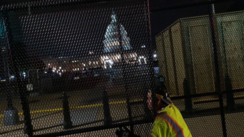 Workers install security fencing around the U.S. Capitol in preparation for this weekend's Justice for J6 rally.