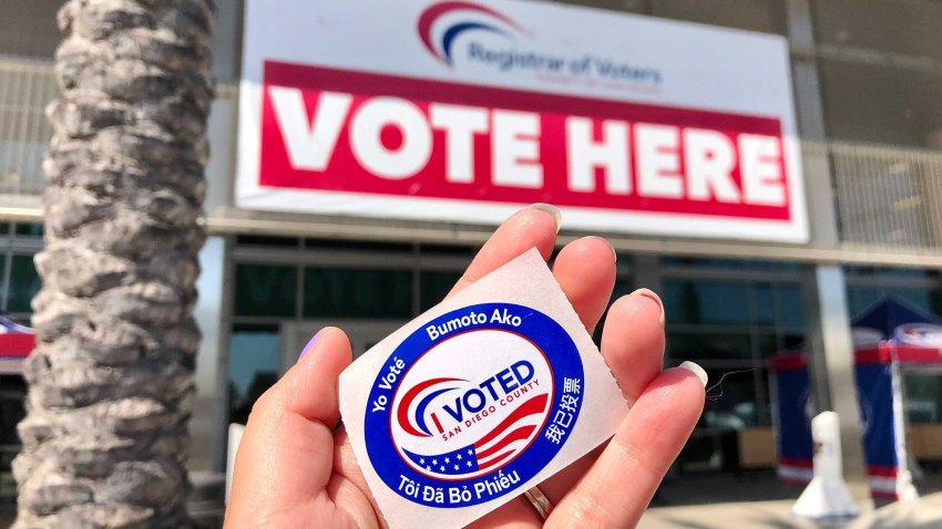 An "I Voted" sticker is held in front of the San Diego Registrar of Voters's office.