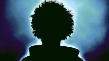 Silhouette of a person with big, curly hair