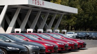 Tesla Model S vehicles parked outside a car dealership in Shanghai.