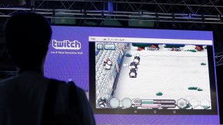File photo: An attendee watches a live demonstration of Link Kit’s Snow World online game displayed in a Twitch Interactive’s streaming video service.