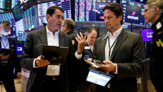 Traders work on the floor of the New York Stock Exchange (NYSE), October 12, 2021.
