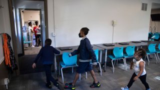 From left, Zihare Wellons, 7, Shahif Wellons, 12, and Janiyah Acie, 3 walk through new Rec2Tech space at Jefferson Recreation Center