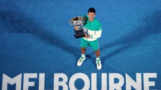Serbia's Novak Djokovic holds the Norman Brookes Challenge Cup after defeating Russia's Daniil Medvedev in the men's singles final at the Australian Open tennis championship in Melbourne, Australia, Sunday, Feb. 21, 2021.