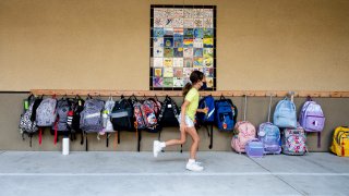 A student rushes to her classroom for the first day of class.