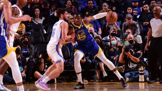 Jonathan Kuminga #00 of the Golden State Warriors backs down against Ty Jerome #16 of the Oklahoma City Thunder on October 30, 2021 at Chase Center in San Francisco, California.