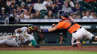 Starling Marte #2 of the Oakland Athletics scores in the eighth inning as Jason Castro #18 of the Houston Astros can’t handle the throw at Minute Maid Park on October 01, 2021 in Houston, Texas.