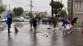 The San Francisco Fire Department posted video on their social media pages of people doing what they can to push water into storm drains during Sunday’s rain. (October 24, 2021)