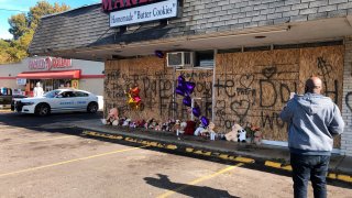 A memorial to slain rapper Young Dolph sits in front of the boarded windows at Makeda's Cookies on Thursday, Nov. 18, 2021, in Memphis, Tenn. Police said Young Dolph was fatally shot inside the popular Memphis