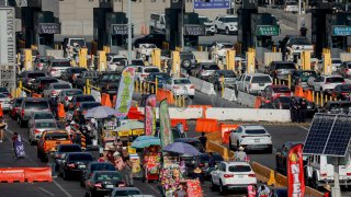 TIJUANA, MEX – NOVEMBER 08: Motorists wait in line to cross the border at the San Ysidro Port of Entry on November 8, 2021 in Tijuana, Mexico.  Monday was the official opening of the border to non-essential visitors as COVID restrictions eased. (Photo by Sandy Huffaker/Getty Images)