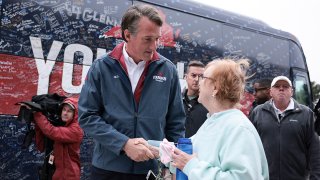 Virginia Republican gubernatorial candidate Glenn Youngkin greets a voter outside a voting location in Chantilly, Virginia.