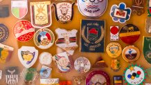 a cork board filled with Olympic pins