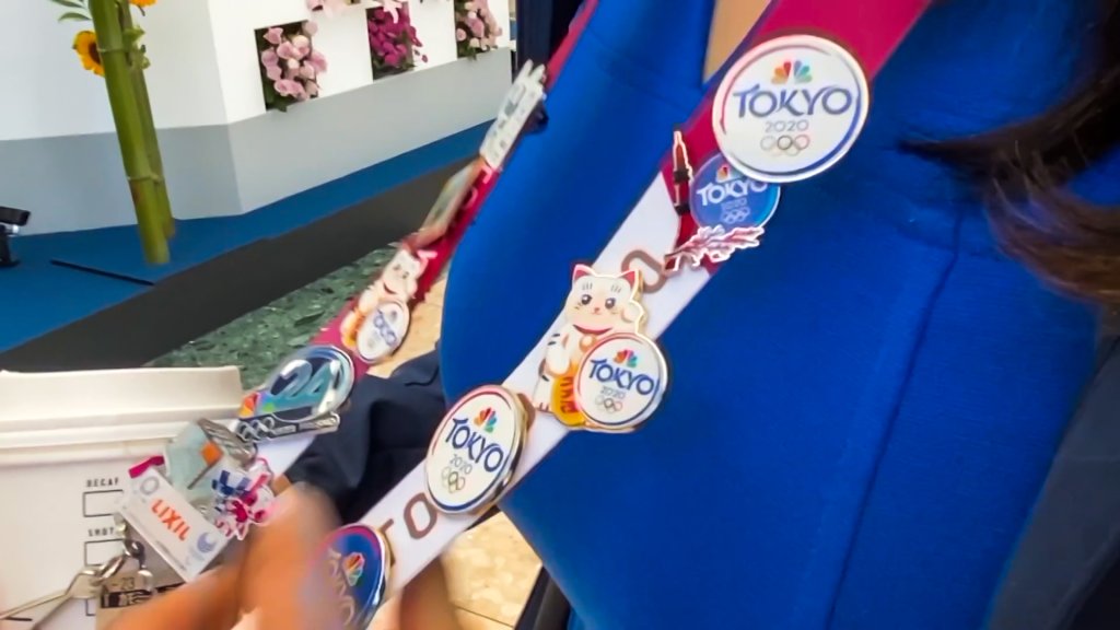 NBC-related Olympic pins on a lanyard