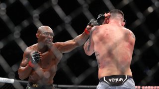 Kamaru Usman (red gloves) competes against Colby Covington (blue gloves) during UFC 268 at Madison Square Garden.