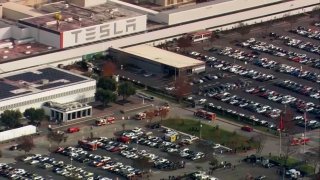 Firefighters respond to a fire at the Tesla facility in Fremont.