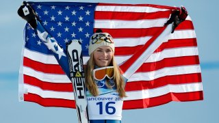 Lindsey Vonn (USA) celebrates after winning the women's downhill gold medal at the 2010 Vancouver Winter Olympics.
