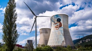 Wind turbine and cooling towers of the Cruas-Meysse nuclear power plant in France, April 12, 2021.