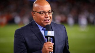 FILE - In this Sept. 5, 2019, file photo, NBC sportscaster Mike Tirico works the sidelines during an NFL football game between the Green Bay Packers and the Chicago Bears in Chicago. Tirico is about to give new meaning to double duty when NBC broadcasts the Olympics and Super Bowl next month. Tirico will anchor the network’s primetime coverage of the Beijing Games, but will also host the Super Bowl pregame show from Los Angeles on Feb. 13 2022.