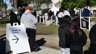 People wait in line for a COVID-19 test.