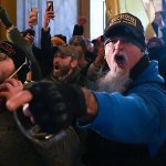 Jon Schaffer, in blue, breaches the Capitol Building with other members of the Oath Keepers militia and other Trump supporters on Jan. 6, 2021. Schaffer was the first to plead guilty for the events of the day.