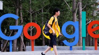 A man walks past the brand logo of Alphabet Inc’s Google outside its office in Beijing, China, August 8, 2018.