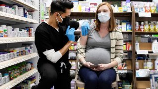 Michelle Melton, who is 35 weeks pregnant, receives the Pfizer-BioNTech vaccine against the coronavirus disease (COVID-19) at Skippack Pharmacy in Schwenksville, Pennsylvania, February 11, 2021.